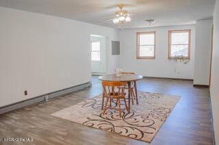 dining area with baseboards and wood finished floors