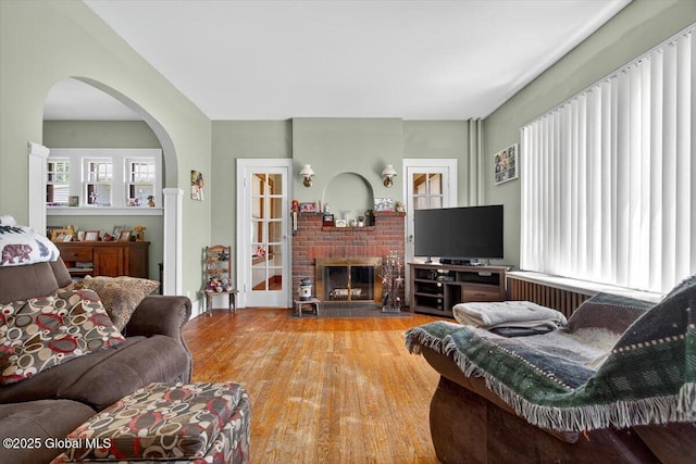 5 Hillview Ave, East Greenbush, NY 12144 - living area with wood finished floors, arched walkways, and a brick fireplace
