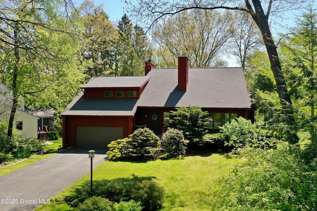 11 Orchard Park Dr, Clifton Park, NY 12065 - view of front of home featuring a chimney, driveway, a front yard, and roof with shingles