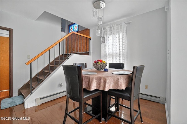 1576 State St, Schenectady, NY 12304 - dining area with a baseboard radiator, stairway, and wood finished floors