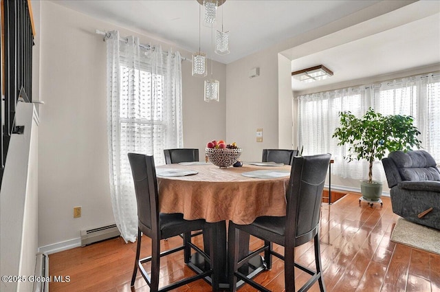 1576 State St, Schenectady, NY 12304 - dining space with a baseboard radiator, wood finished floors, and baseboards