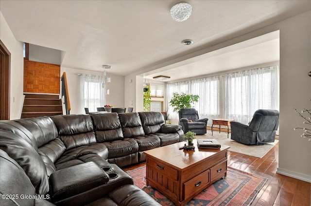 1576 State St, Schenectady, NY 12304 - living room featuring hardwood / wood-style flooring, stairway, baseboards, and a chandelier