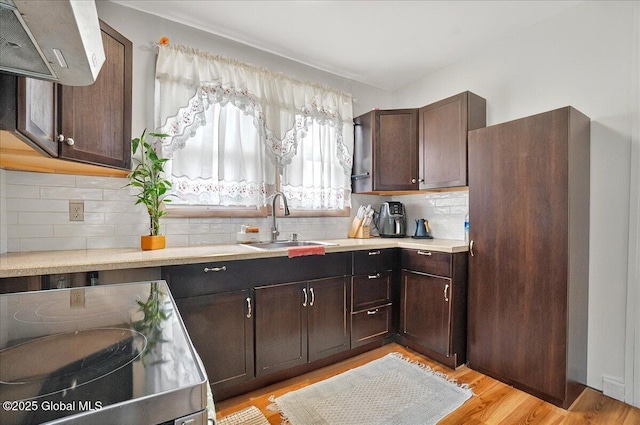 1576 State St, Schenectady, NY 12304 - kitchen featuring a sink, light countertops, tasteful backsplash, and dark brown cabinetry