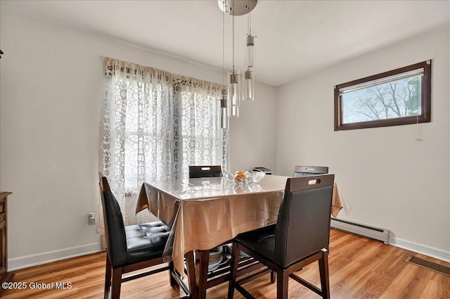 1576 State St, Schenectady, NY 12304 - dining room featuring a baseboard radiator, baseboards, and light wood finished floors