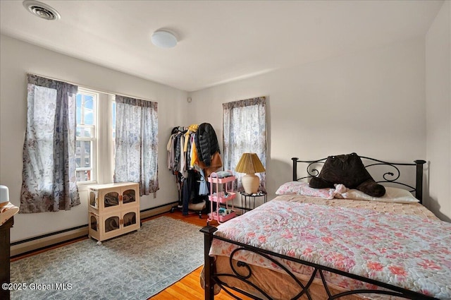 1576 State St, Schenectady, NY 12304 - bedroom featuring a baseboard radiator and wood finished floors