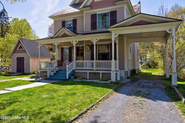 victorian-style house featuring a porch and a front lawn