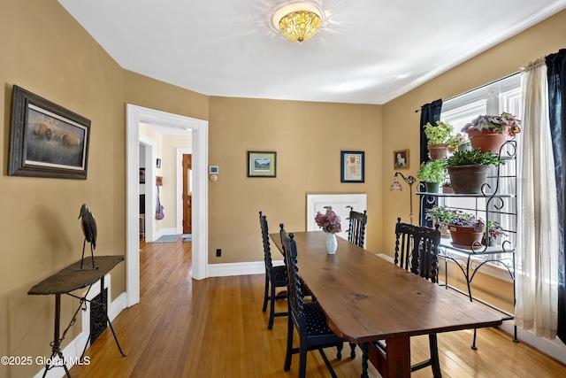 dining area with hardwood / wood-style flooring and baseboards