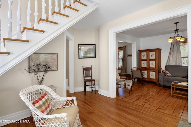 living area with hardwood / wood-style flooring and baseboards