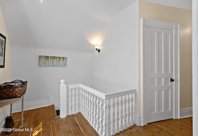 stairs featuring hardwood / wood-style flooring and baseboards
