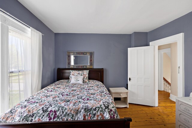 bedroom with hardwood / wood-style flooring