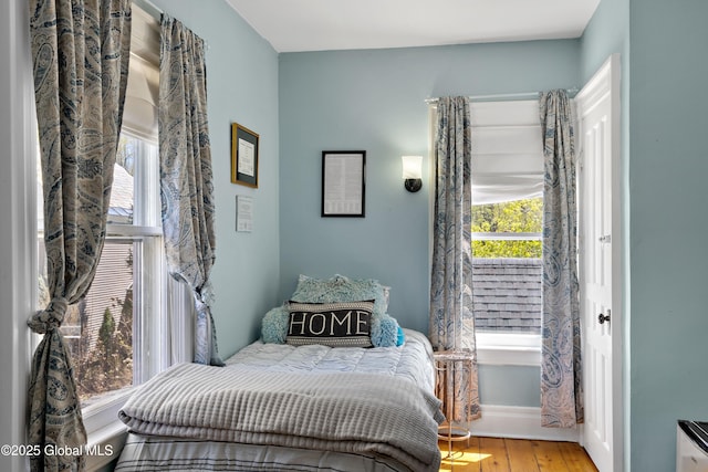 bedroom with wood finished floors and baseboards