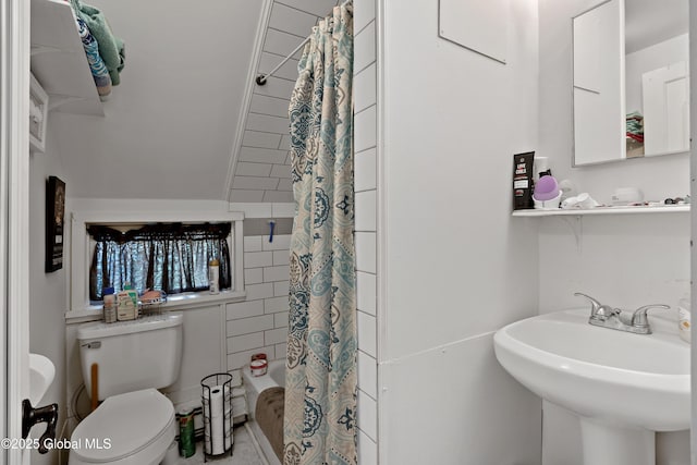 full bath with toilet, shower / tub combo, and a sink