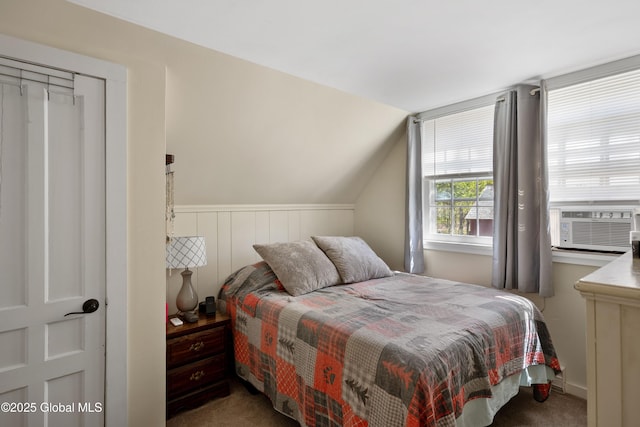 carpeted bedroom featuring cooling unit and lofted ceiling