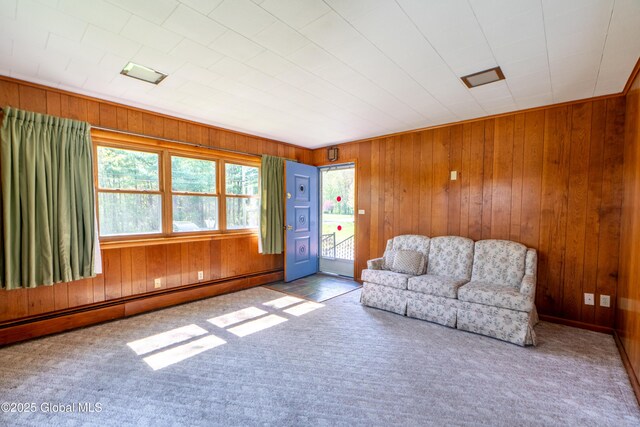 188 Fort Edward Rd, Moreau, NY 12828 - living room featuring healthy amount of natural light, carpet floors, baseboard heating, and wood walls