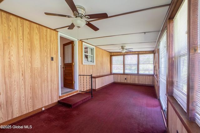 188 Fort Edward Rd, Moreau, NY 12828 - unfurnished sunroom featuring carpet floors, wood walls, and baseboards