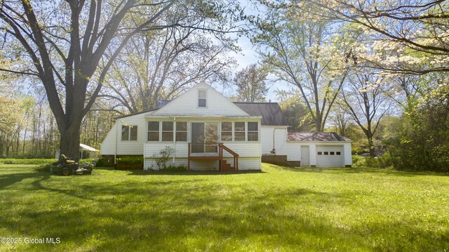 188 Fort Edward Rd, Moreau, NY 12828 - back of house with a sunroom, a yard, an attached garage, and entry steps