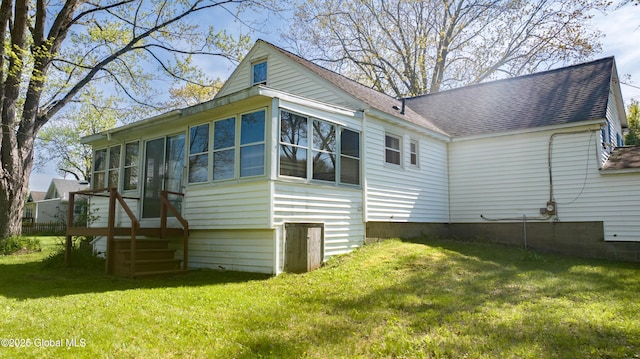 188 Fort Edward Rd, Moreau, NY 12828 - rear view of property with a shingled roof, a yard, and a sunroom