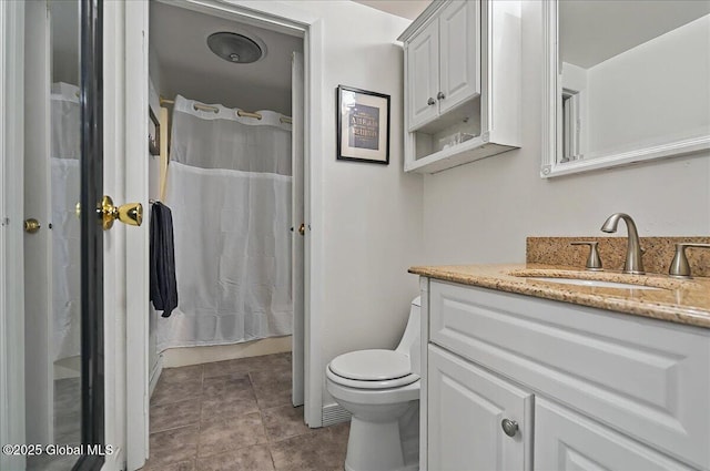 bathroom featuring toilet, vanity, tile patterned floors, and curtained shower