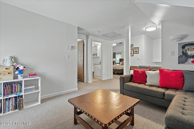 living area featuring light colored carpet and baseboards