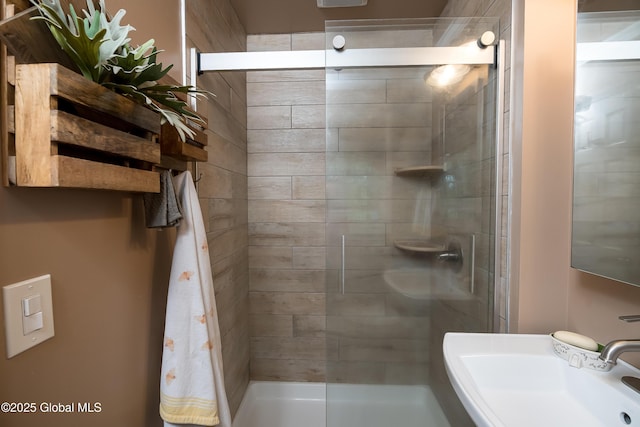 bathroom featuring a sink and a shower stall