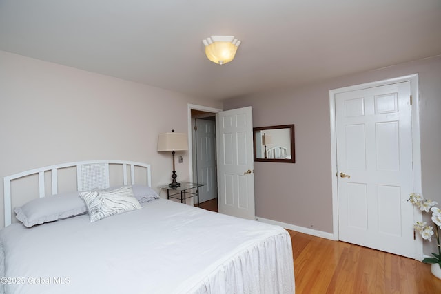 bedroom with light wood-style flooring and baseboards