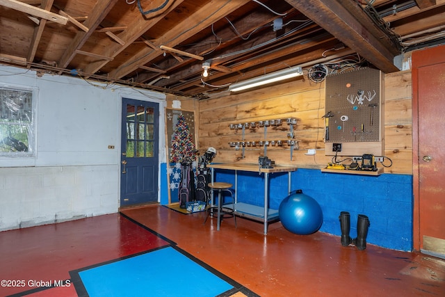 exercise room with a workshop area and concrete block wall