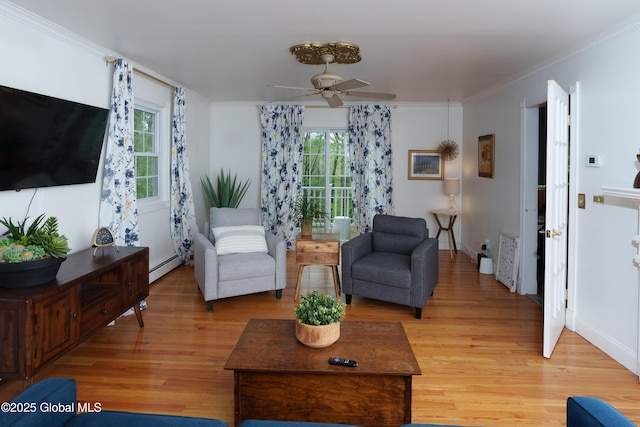 living area with baseboard heating, light wood-style floors, a ceiling fan, and ornamental molding