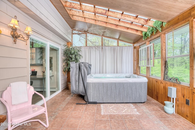 sunroom featuring a hot tub, wooden walls, vaulted ceiling, wooden ceiling, and baseboard heating