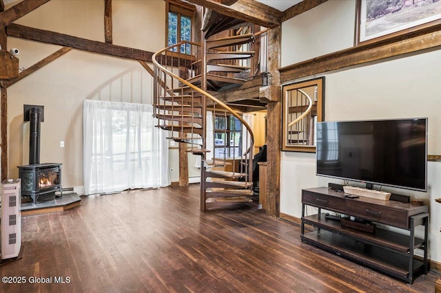 11 Cotton Ct, Bolton, NY 12824 - unfurnished living room featuring a high ceiling, stairway, wood finished floors, a wood stove, and baseboards