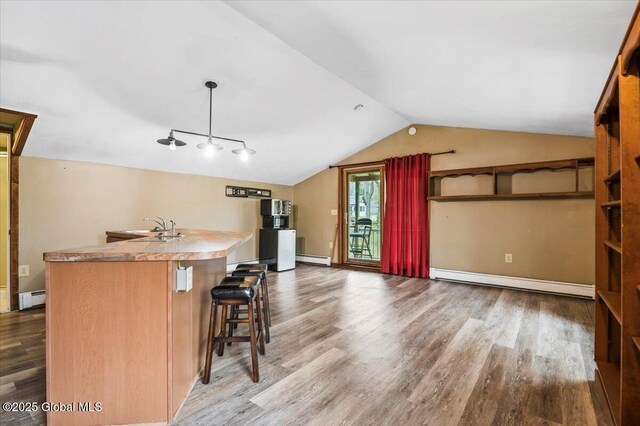 11 Cotton Ct, Bolton, NY 12824 - kitchen with a baseboard heating unit, wood finished floors, and lofted ceiling