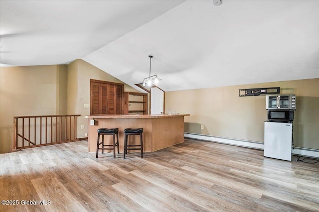 11 Cotton Ct, Bolton, NY 12824 - kitchen with a baseboard radiator, light wood-style floors, lofted ceiling, baseboard heating, and pendant lighting