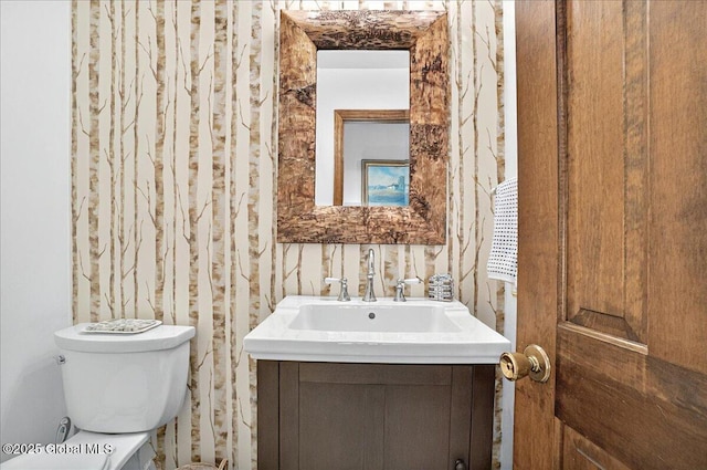 bathroom featuring toilet and vanity