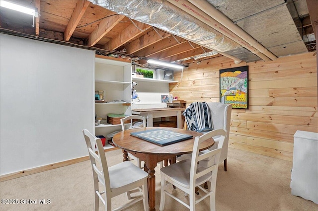 carpeted dining area with wooden walls