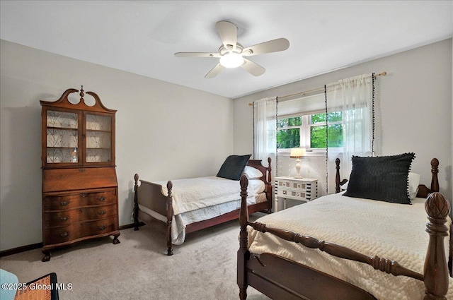 bedroom featuring light colored carpet, baseboards, and ceiling fan