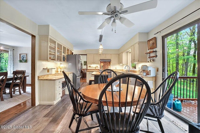 dining room featuring wood finished floors, baseboards, and ceiling fan