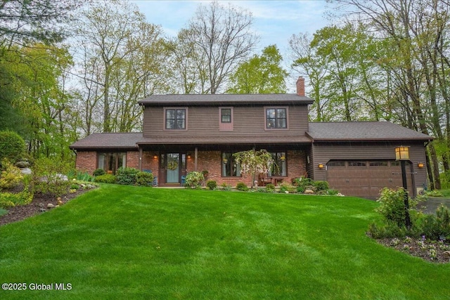 view of front of home with brick siding, an attached garage, a front lawn, and a chimney