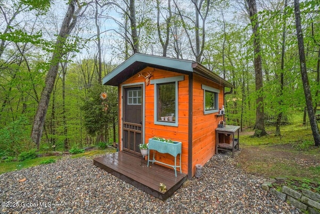 view of outbuilding featuring an outbuilding and a view of trees