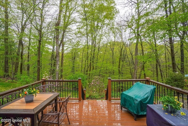 wooden terrace with a view of trees