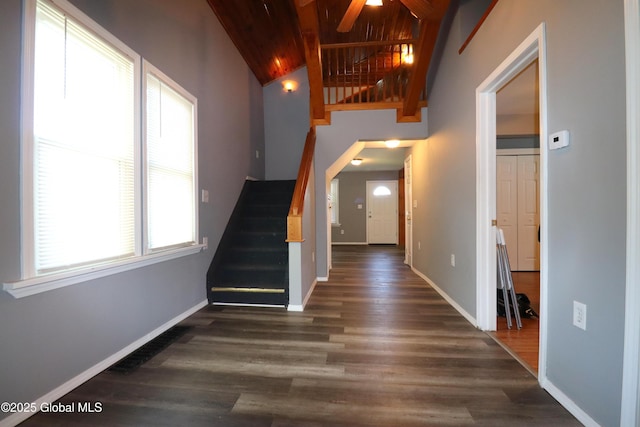 stairway featuring wood finished floors, baseboards, vaulted ceiling, ceiling fan, and wooden ceiling