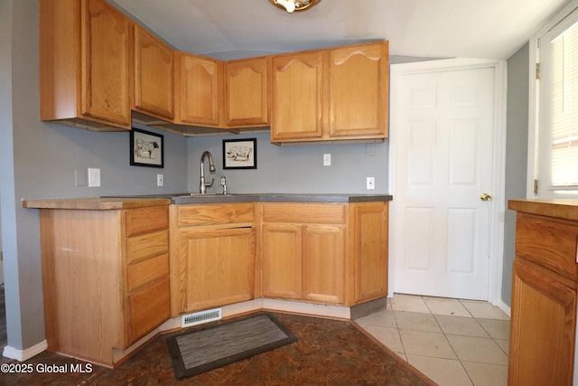 kitchen featuring a sink and light tile patterned floors