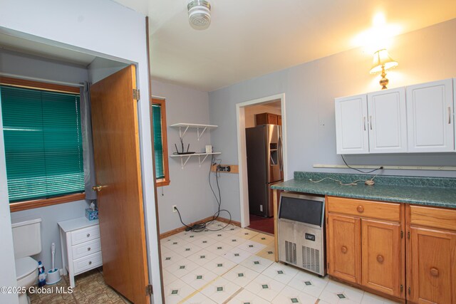 bathroom with baseboards and toilet