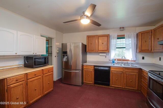 kitchen with stainless steel appliances, a sink, light countertops, and a ceiling fan