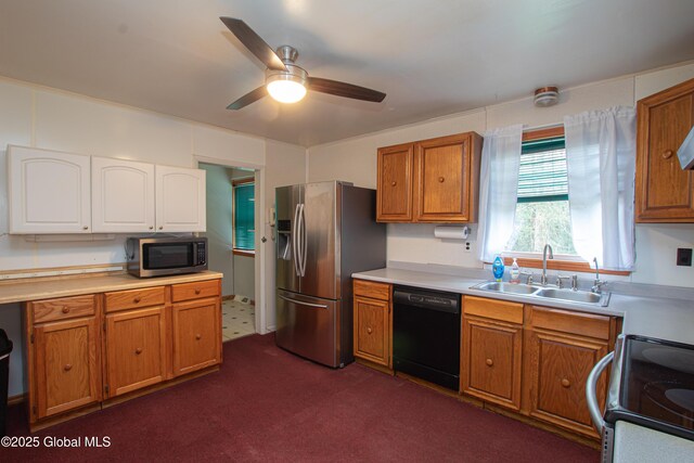 kitchen featuring stainless steel appliances, a sink, ceiling fan, and light countertops