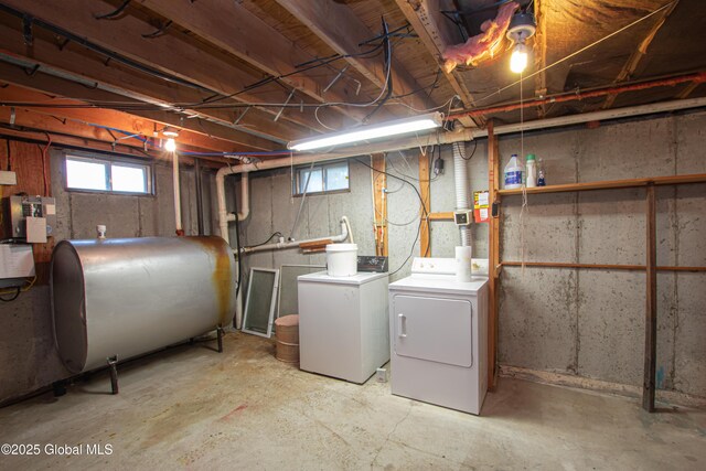 basement featuring oil tank and washer and clothes dryer