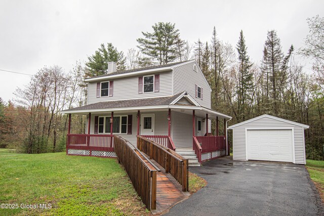 country-style home with a porch, an outbuilding, a chimney, a front yard, and a garage