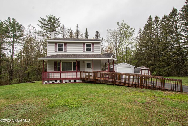 view of front of property with a garage, an outdoor structure, a porch, and a front lawn