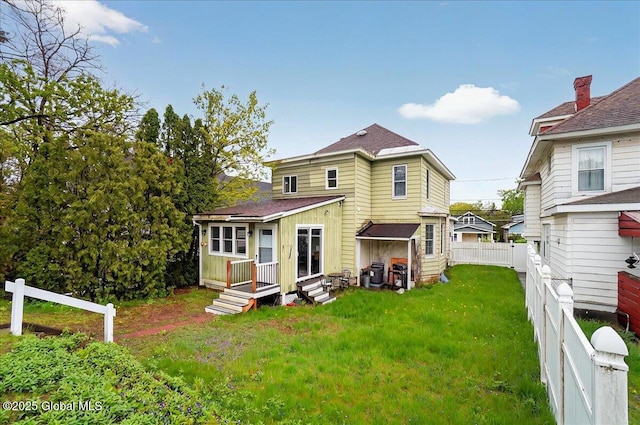 back of property with a shingled roof