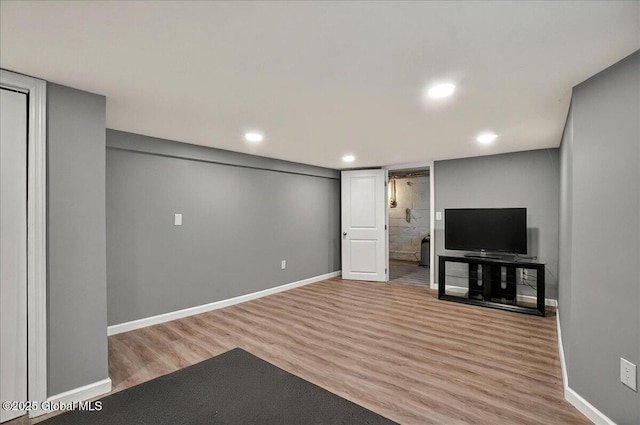 finished basement with wood finished floors, baseboards, and recessed lighting