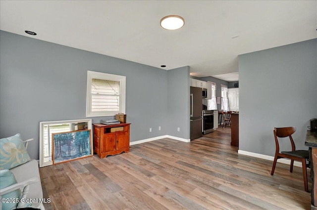 living area featuring wood finished floors and baseboards