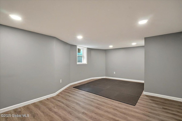 below grade area featuring wood finished floors, recessed lighting, and baseboards